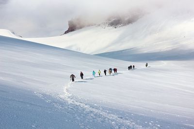 People on snowcapped mountain