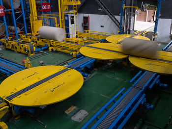 High angle view of yellow boats moored at factory