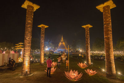 Panoramic view of illuminated building against sky at night