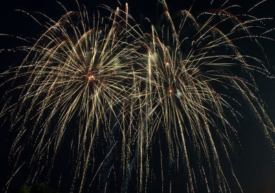 Low angle view of firework display at night