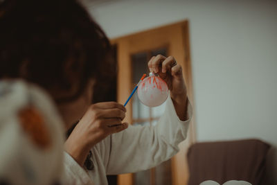 Midsection of woman holding christmas decoration