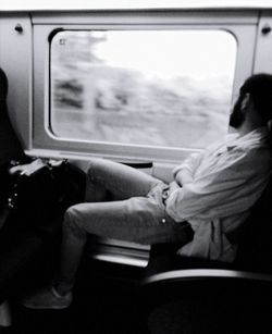 Rear view of people sitting in train