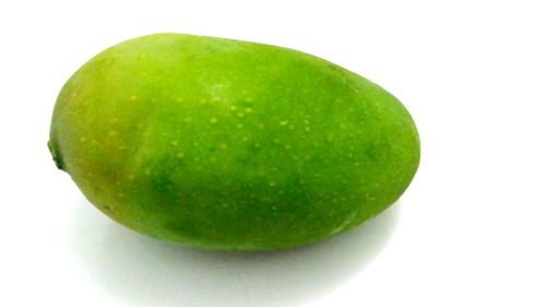 Close-up of fresh green apple against white background