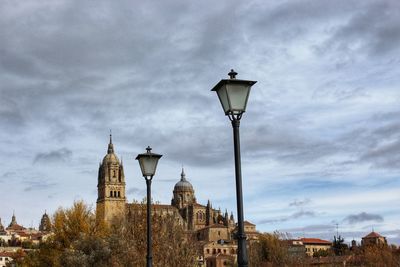 Street light by building against sky