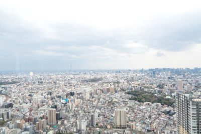 High angle view of city buildings against sky