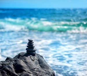 Close-up of rocks on beach against sky