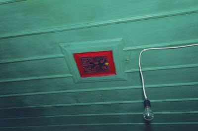 Close-up of closed metal hanging against wall