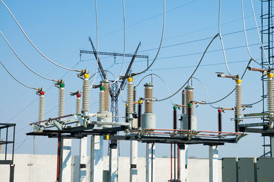 Low angle view of electricity pylon against sky