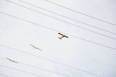 Low angle view of airplane flying against clear sky