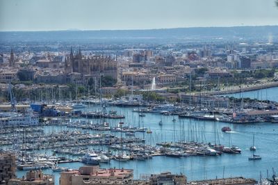 Aerial view of cityscape by sea against sky