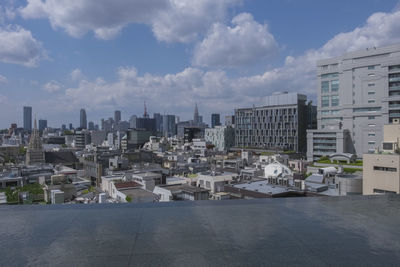 Buildings against cloudy sky