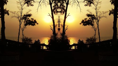 Silhouette trees against sky during sunset