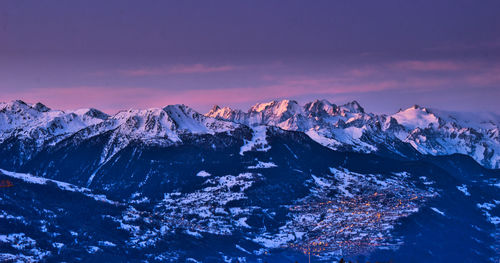 Scenic view of snowcapped mountains against sky during sunset