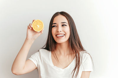 Portrait of a smiling young woman over white background