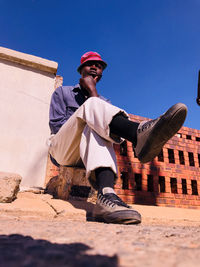 Low angle view of man against built structure