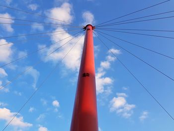 Low angle view of telephone pole against blue sky