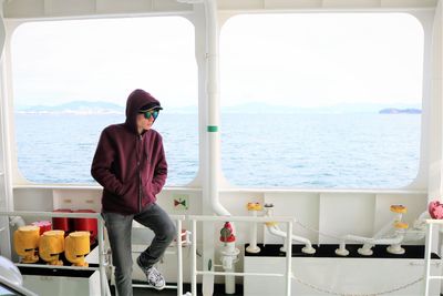 Full length of man standing by sea against sky