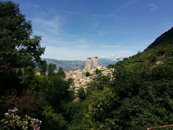 Trees and plants growing in fort against sky