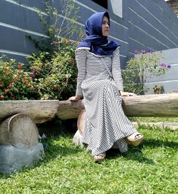 Low angle view of woman wearing hijab while sitting on bench