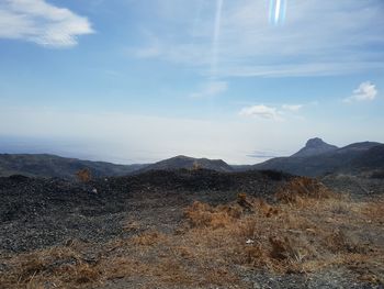 Scenic view of arid landscape against sky