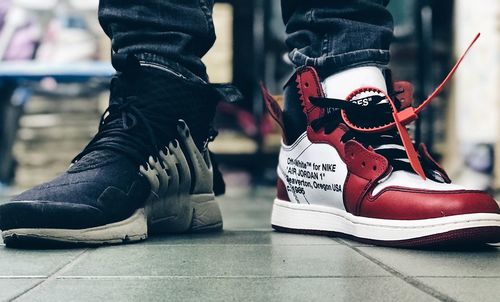 Low section of man wearing shoes