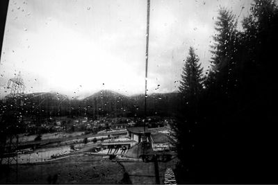 Road seen through wet window in rainy season