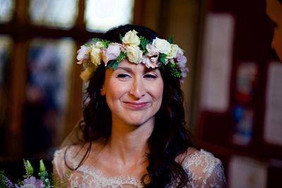 Portrait of happy woman with red flower