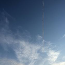 Low angle view of vapor trails in sky