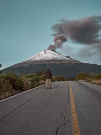 Rear view of man on road against sky