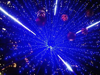 Low angle view of firework display at night