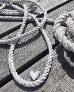 High angle view of rope tied to boat moored at pier