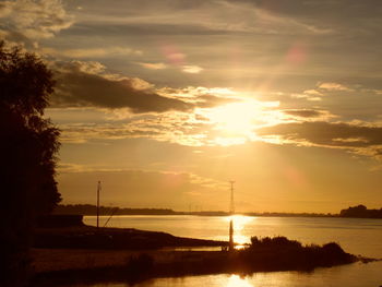 Scenic view of river at sunset