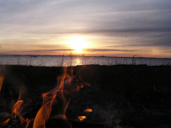 Bonfire against sky during sunset