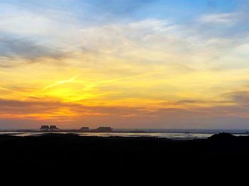 Scenic view of beach against sky during sunset