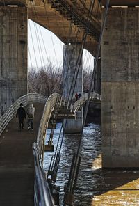 Footbridge over river against sky