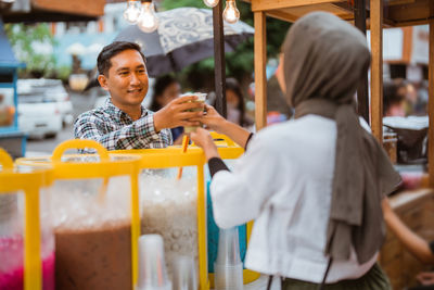 Rear view of woman standing in cafe