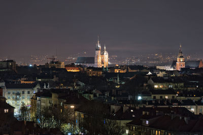 High angle view of illuminated buildings in city at night