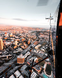 Aerial view of cityscape against sky during sunset