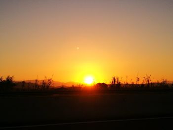 Silhouette landscape against clear sky during sunset