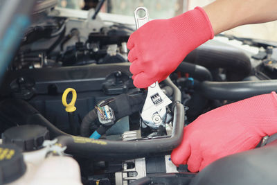 Close-up of person working on car