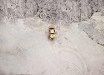 Aerial view of bulldozer on sand