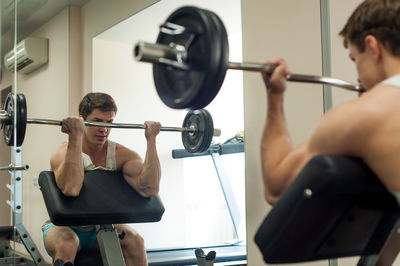 Young man exercising in gym