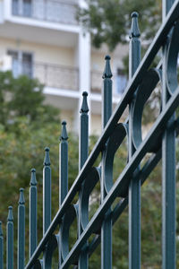Close-up of metal fence against building