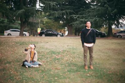 Full length of a man smiling while sitting on tree
