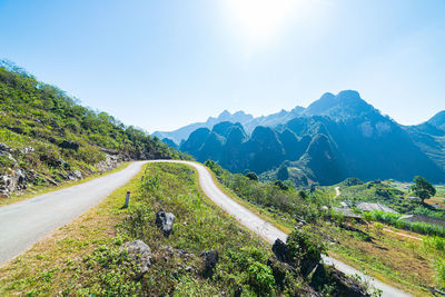 Road by mountain against sky