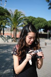 Young woman photographing with camera