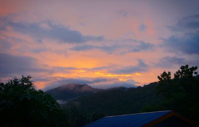 Scenic view of mountains against orange sky