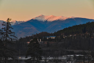 Scenic view of snowcapped mountains against sky during sunset