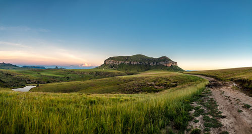Scenic view of land against sky during sunset