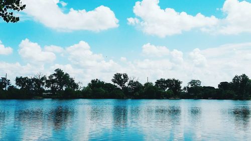 Scenic view of calm lake against cloudy sky